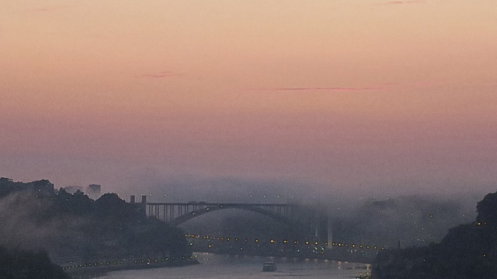 Beautiful pink sunset in Porto, Portugal, view on Porto's bridge